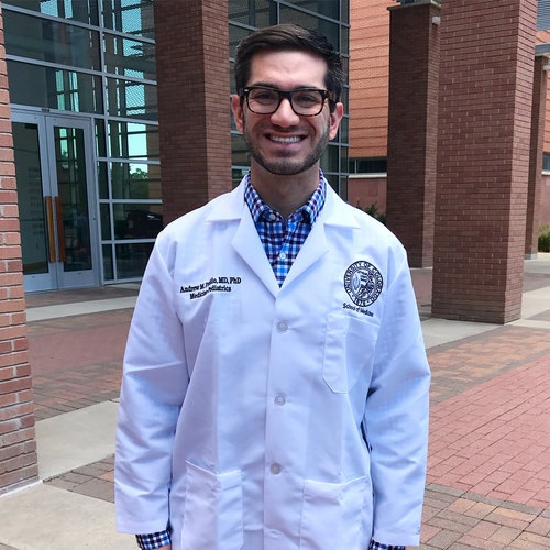 Dr. Andrew Fredd (BS '10) wearing lab coat