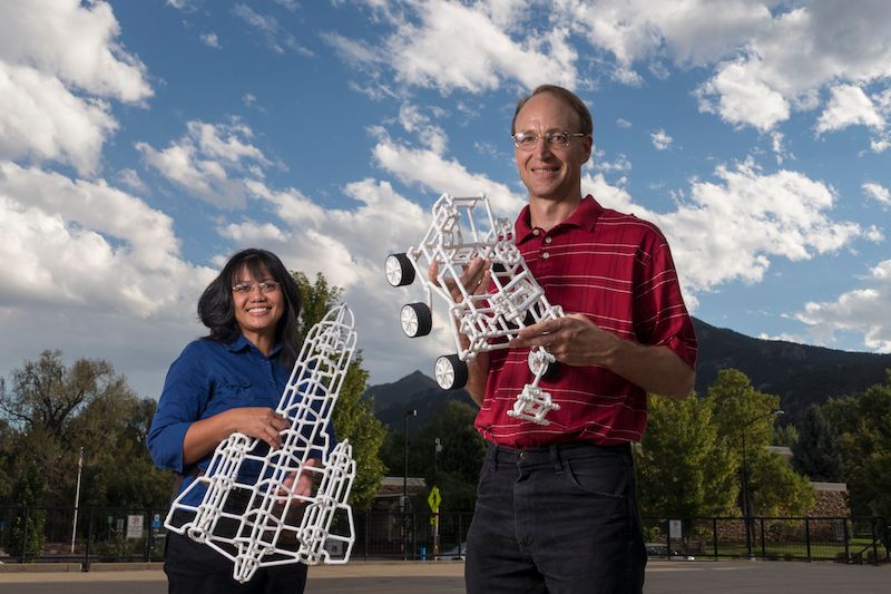 Monica (BS '95) and Charles Sharman (BS ’95) with models built using Crossbeams.Photo: Glenn Asakwa